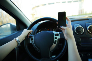 Close-up of a businesswoman sending a text while driving to work